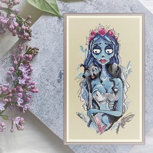 May include: Cross-stitch pattern of a pale blue bride with black hair and a floral crown holding two black cats. The bride is wearing a white dress and a veil. The background is a light beige.