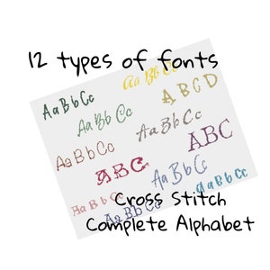 May include: A white sheet of paper with the text "12 types of fonts" written in black ink. The paper is filled with different fonts of the letters "A", "B", and "C" in various colors. The text "Cross Stitch Complete Alphabet" is written in black ink at the bottom of the page.