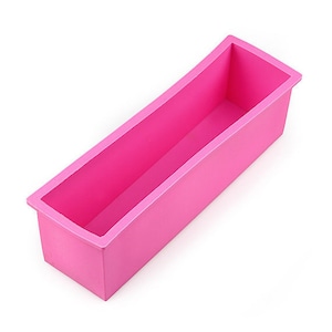 Può includere: Uno stampo in silicone rosa per fare il sapone. Lo stampo è rettangolare con bordi arrotondati ed è progettato per creare una saponetta.