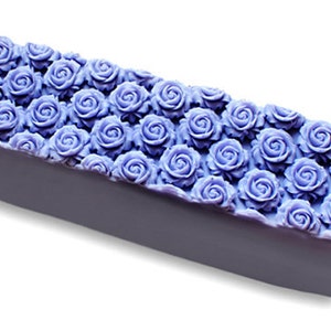 May include: A lavender-colored bar of soap with a decorative design of purple roses on the top.