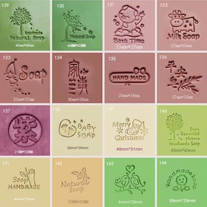 May include: A set of 12 rubber stamps for soap making. The stamps feature various designs, including a tree, a pig, a cow, a hand, a bird, and a Christmas stocking. The stamps are made of rubber and have a wooden handle. The stamps are approximately 1.5 inches in diameter.