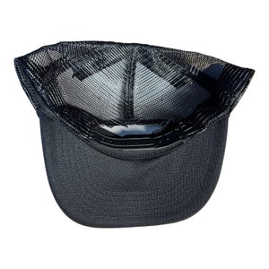 May include: Black mesh trucker hat with a black brim. The hat has a black mesh panel on the back and a black fabric panel on the front.