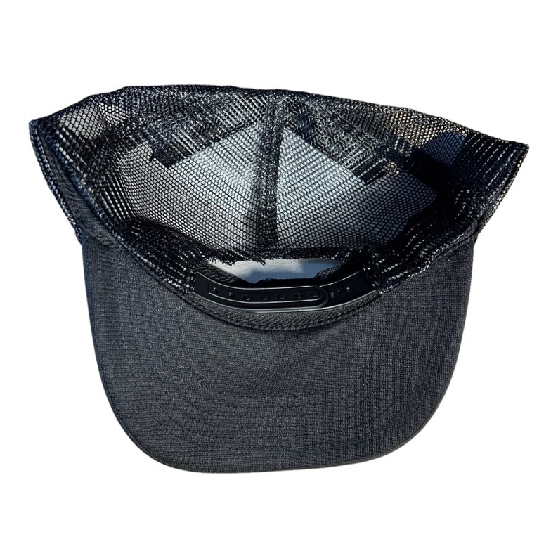 May include: Black mesh trucker hat with a black brim. The hat has a black mesh panel on the back and a black fabric panel on the front.