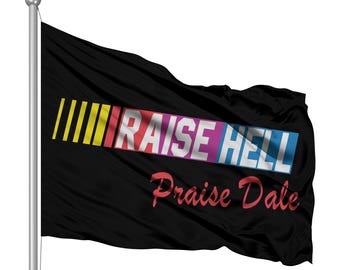 May include: A black flag with the words "Raise Hell" in colourful letters and "Praise Dale" in red letters below. The flag is waving in the wind.