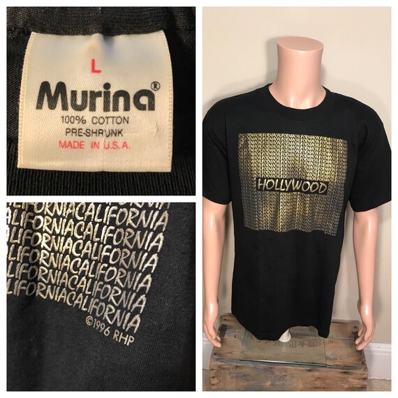 Camisa negra con letras doradas hotsell