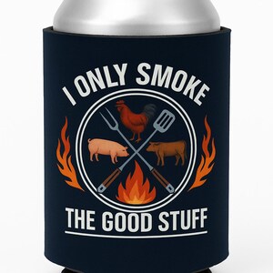 May include: Navy blue can cooler with the text "I Only Smoke The Good Stuff." The design includes a rooster, pig, and cow inside a circle with crossed grilling tools and flames.