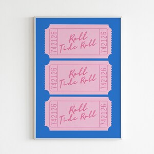 May include: Three pink tickets with the text "Roll Tide Roll" and the number "742126" printed on each ticket. The tickets are displayed on a blue background within a silver frame.