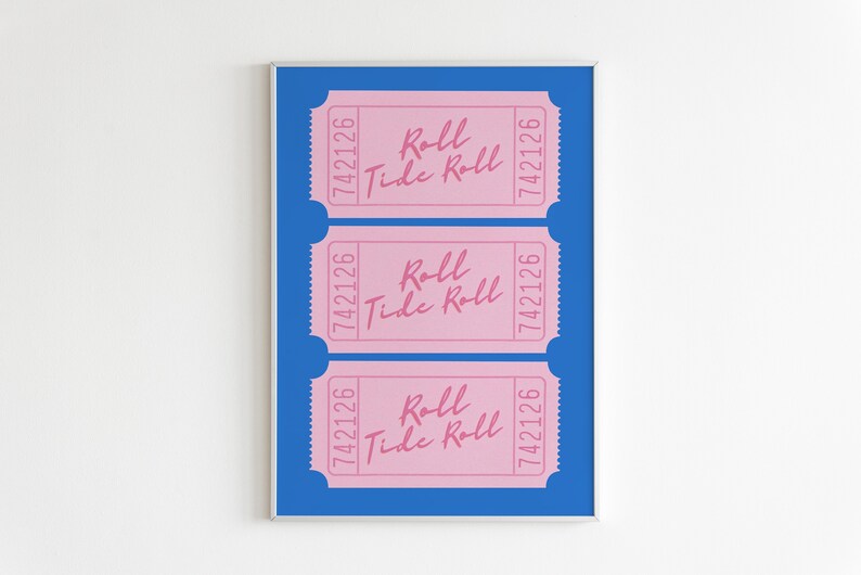 May include: Three pink tickets with the text "Roll Tide Roll" and the number "742126" printed on each ticket. The tickets are displayed on a blue background within a silver frame.