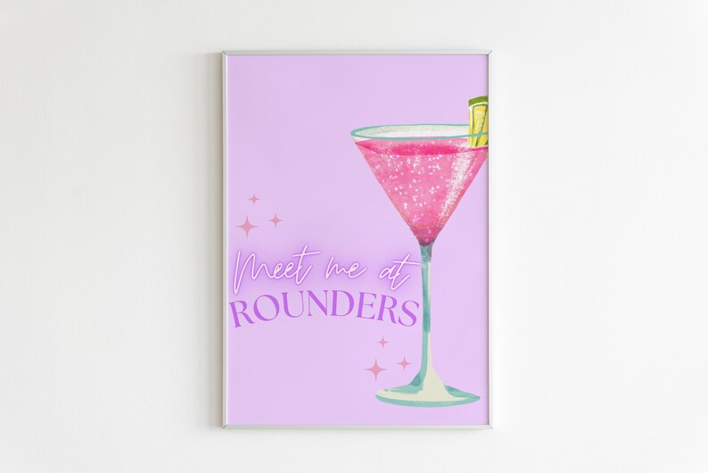 May include: A pink cocktail with a lime wedge in a martini glass on a light purple background with the text "Meet me at Rounders" in purple.
