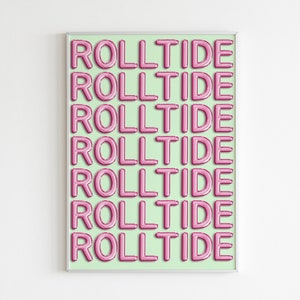 May include: A framed print with a light green background and the words "Roll Tide" repeated seven times in pink, bubble-like letters.