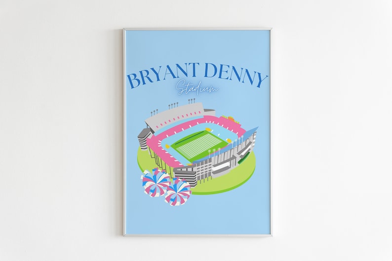 May include: A blue and pink illustration of Bryant Denny Stadium, home of the Alabama Crimson Tide football team. The stadium is surrounded by green grass and two blue and pink pom-poms.