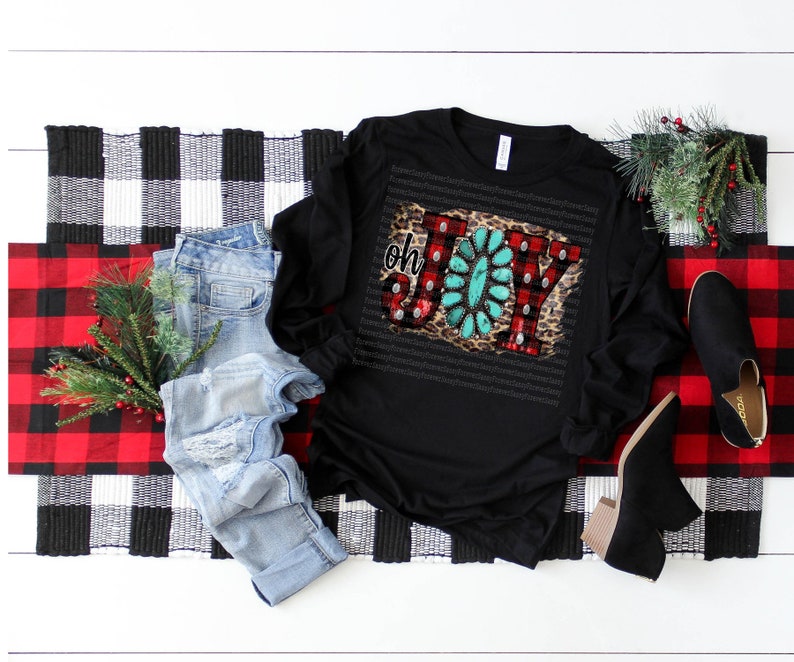 May include: Black long-sleeve shirt with a festive "Oh Joy" design featuring red and white plaid, turquoise, and leopard print. The design is embellished with rhinestones.