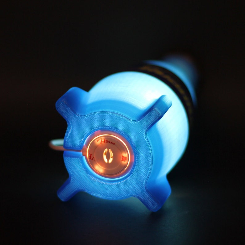 May include: A blue light-up novelty weapon with a red button that says "V.I.L.L.A.I.N."