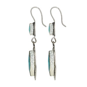 May include: A pair of silver dangle earrings with turquoise stones. The earrings have a simple design with a small turquoise stone at the top and a larger turquoise stone at the bottom.