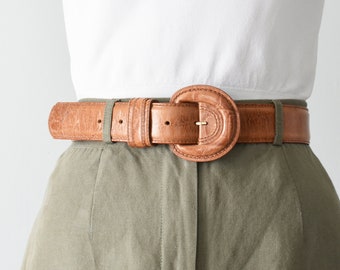 vintage tan leather belt with round buckle