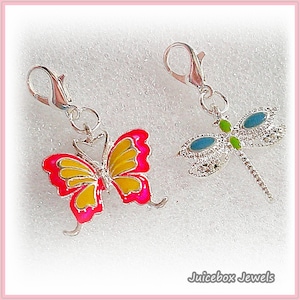 May include: Two silver-toned charms: a butterfly with yellow and pink wings, and a dragonfly with blue and green accents. Both charms have lobster claw clasps for easy attachment. The charms are decorative.
