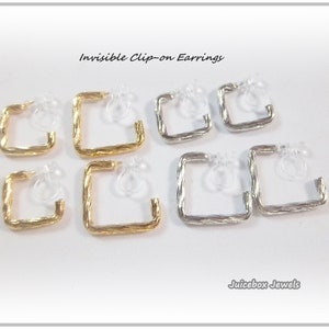 May include: A set of six invisible clip-on earrings. Three are gold and three are silver. Each earring is a square shape with a twisted wire design.