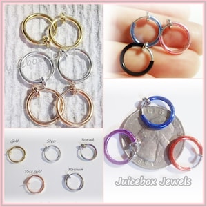 May include: A variety of non-pierced hoop earrings in different colors and finishes, including gold, silver, rose gold, peacock, and platinum. The earrings are shown on a white background and on a US quarter for size comparison. The text "Juicebox Jewels" is visible in the bottom right corner of the image.