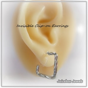 May include: Silver clip-on earrings with a twisted wire design. The earrings are shown on a model's ear. "Invisible Clip-on Earrings" and "Juicebox Jewels" are written in the image.