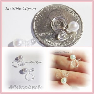 May include: Two pairs of clear plastic clip-on earrings with white pearl-like balls. The earrings are shown next to a US quarter for size comparison. The text "Invisible Clip-on" is written on the image.