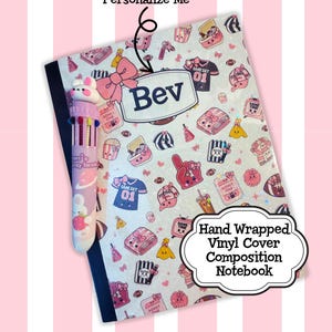 May include: A composition notebook with a hand-wrapped vinyl cover featuring a repeating pattern of pink and white sports-themed icons, including footballs, jerseys, and bows. The name Bev is printed in a central label. A multi-colour pen is included.