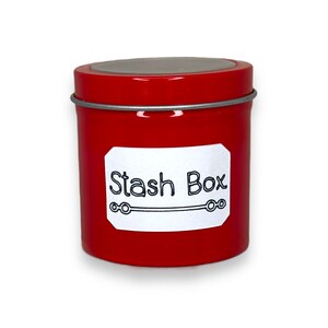 May include: A red metal tin with a silver lid and a white label that says "Stash Box".