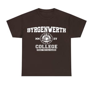 May include: A dark brown t-shirt with a white graphic design. The graphic features the text "Byrgenwerth College" with a stylized eye and the text "Fear the Old Blood".