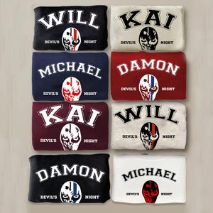 May include: Eight different sweatshirts with various names printed on the front. The names are "Will", "Kai", "Michael", and "Damon". Each sweatshirt has a skull graphic with a red, white, and black color scheme. The text "Devil's Night" is printed below the graphic.