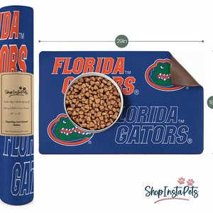 May include: A blue and orange pet feeding mat with the text "FLORIDA GATORS" and an alligator graphic. The mat is 29 inches wide and 18 inches long.
