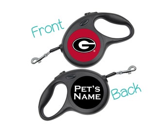 May include: Black retractable dog leash with a red and white University of Georgia logo on the front and "PET'S NAME" on the back.