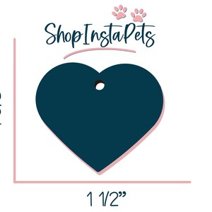 May include: A dark blue heart-shaped tag with a hole for a ring or string. The tag is 1 1/2 inches wide and 1 5/8 inches tall. Shop Insta Pets is written in pink script above the tag.
