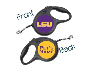 May include: A black retractable dog leash with a purple and gold LSU logo on the front and a yellow circle with the text "PET'S NAME" on the back.