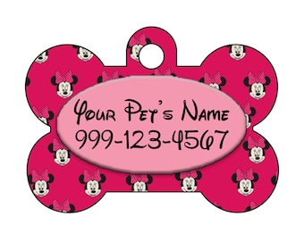 May include: Pink bone-shaped dog tag with a Minnie Mouse pattern and a pink oval with the text "Your Pet's Name 999-123-4567".