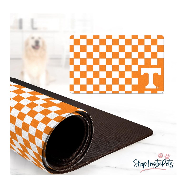 May include: Orange and white checkered pet mat with a large white "T" in the center. The mat is rolled up and has a brown non-slip backing.