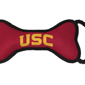 May include: Red and black bone-shaped dog toy with a yellow "USC" logo.