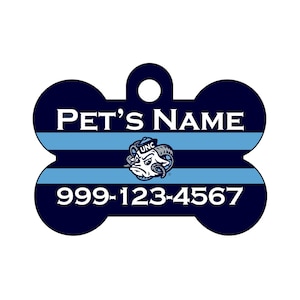 May include: Blue and white bone-shaped pet ID tag with a UNC Tar Heels logo and the text "PET'S NAME" and "999-123-4567".