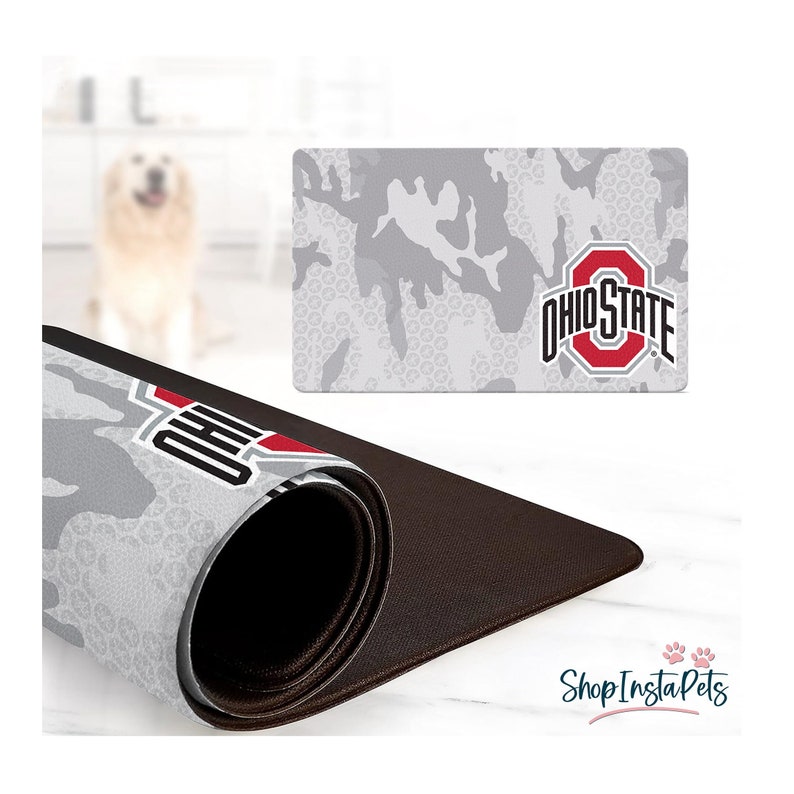 May include: A gray and white camouflage pattern mousepad with the Ohio State logo in red and white. The mousepad is rolled up, revealing a brown underside. The words "Shop Insta Pets" are in the bottom right corner.