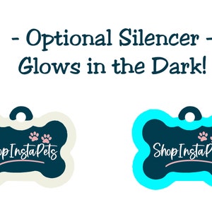 May include: Two bone-shaped dog tags with a dark blue background and white text that reads "Shop Insta Pets". The tag on the left has a white bone shape and the tag on the right has a light blue bone shape. Both tags have pink paw prints on the top. The text above the tags reads "Optional Silencer - Glows in the Dark!"