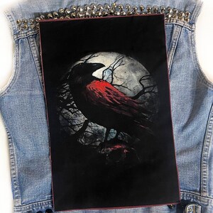 May include: A black and red crow with a full moon in the background. The crow is perched on a branch in a dark forest. The moon is full and bright, casting a soft glow on the scene.