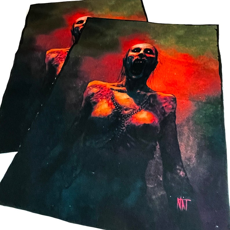May include: A black and red fabric patch featuring a graphic of a woman with a distressed, pale face and a chain around her neck. The woman is screaming with her mouth open and her eyes wide. The background is a dark red and black with a green tint. The patch is signed "NAT" in the bottom right corner.