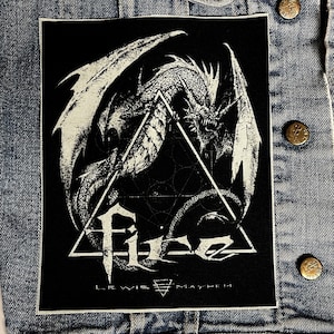 May include: Black and white embroidered patch featuring a dragon with wings spread wide, inside a triangle with the text "F.I.G. LEWIS MAYHEM" below.