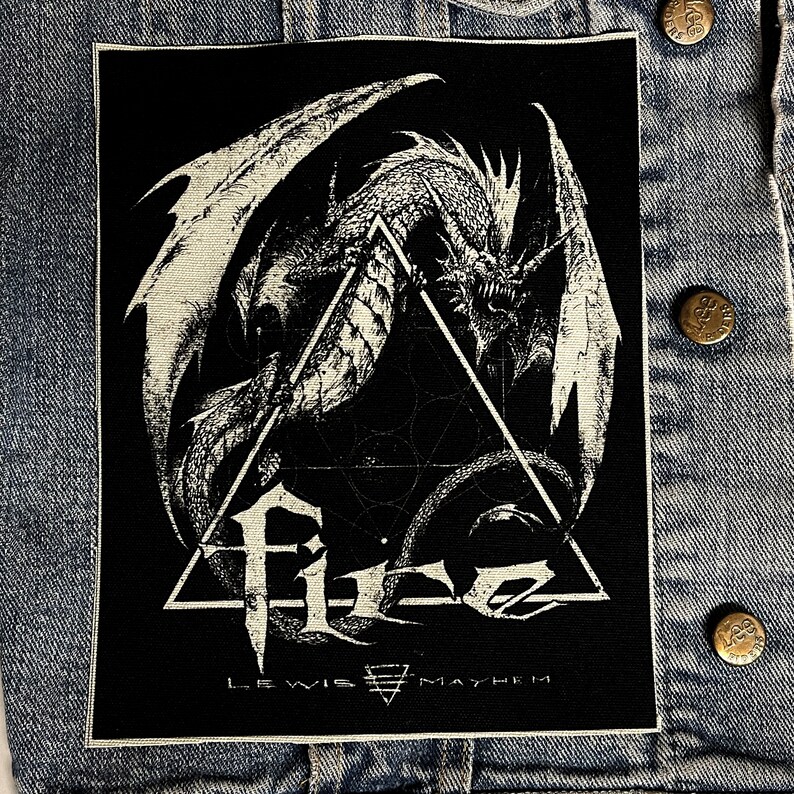 May include: Black and white embroidered patch featuring a dragon with wings spread wide, inside a triangle with the text "F.I.G. LEWIS MAYHEM" below.
