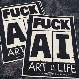 May include: Two white fabric patches with black text. The top patch says "FUCK ART" and the bottom patch says "FUCK AI ART IS LIFE LEWIS MAYHEM".