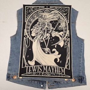 May include: Black and white patch featuring an art nouveau style illustration of a skeleton with long hair and a flowing gown. The text "LEWIS MAYHEM" is at the bottom of the patch.