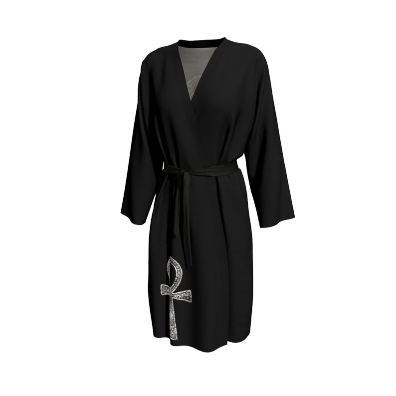 May include: Black robe with a silver Ankh symbol on the front. The robe has a tie belt and long sleeves.