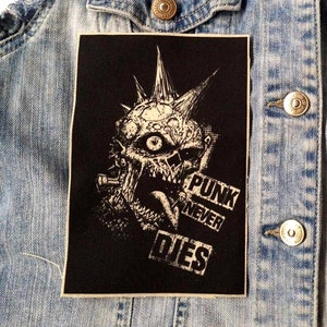 May include: Black and white punk rock patch with a monster with a mohawk and the text "Punk Never Dies".