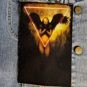 May include: A black and white image of an angel with wings, a snake head, and a halo. The angel is standing in a triangle with a glowing outline. The background is a dark yellow and orange.
