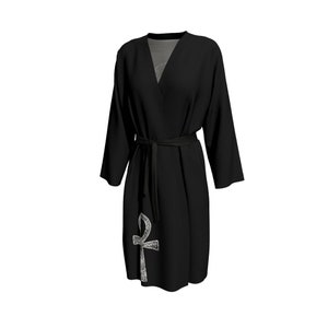 May include: Black robe with a silver Ankh symbol on the front. The robe has a tie belt and long sleeves.