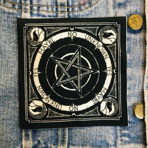 May include: Black and white square patch with a pentagram design. The patch features the words "YES", "NO", "MAYBE", and "UNKNOWN" around the edges. Decorative circular elements and crescent moons are also present.
