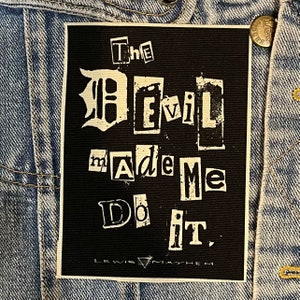 May include: Black and white patch with the text "The Devil Made Me Do It." in a ransom note style font. The text "Lewis & Mayhem" is at the bottom of the patch.